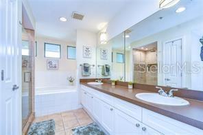 bathroom with vanity, tile patterned floors, and separate shower and tub