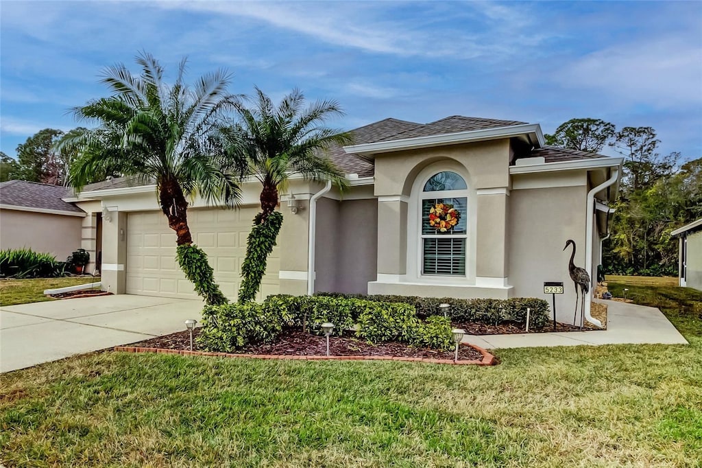 view of front of home featuring a garage and a front lawn