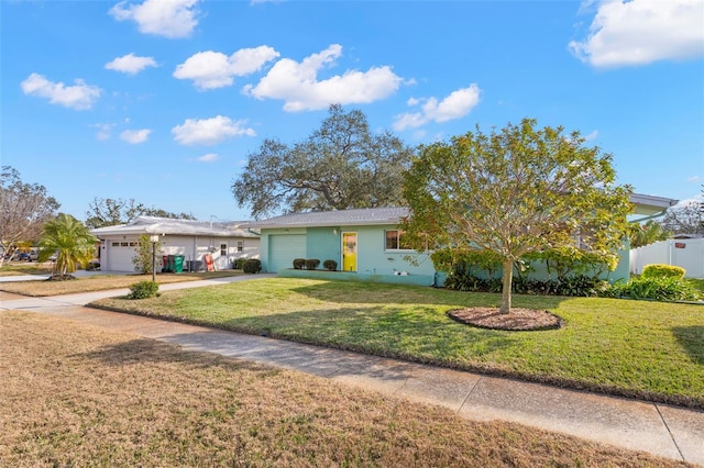 view of front of house with a garage and a front lawn