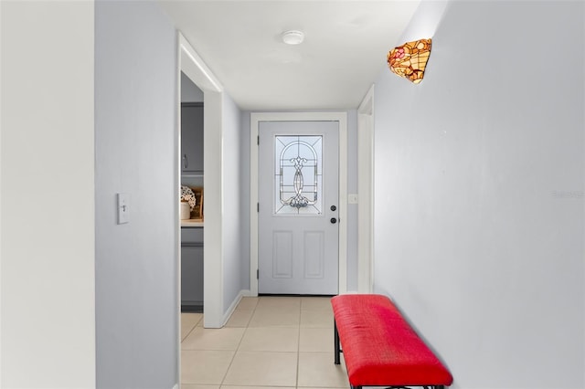 doorway to outside featuring light tile patterned flooring