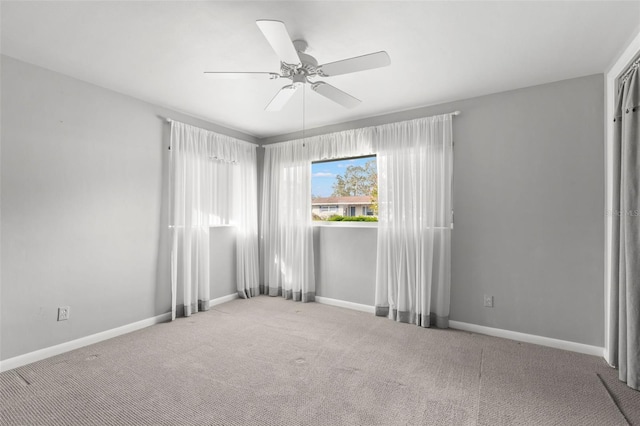 empty room featuring ceiling fan and carpet flooring