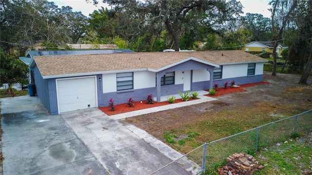 ranch-style house featuring solar panels and a garage