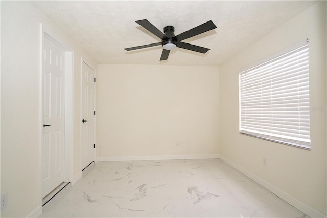 unfurnished room with ceiling fan