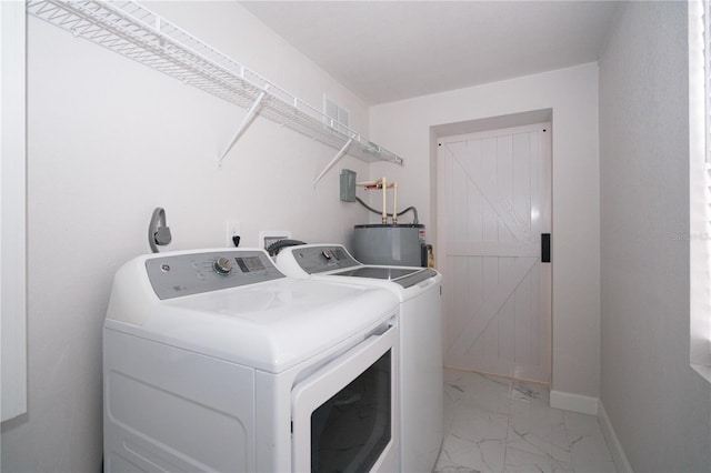 laundry room with separate washer and dryer and water heater