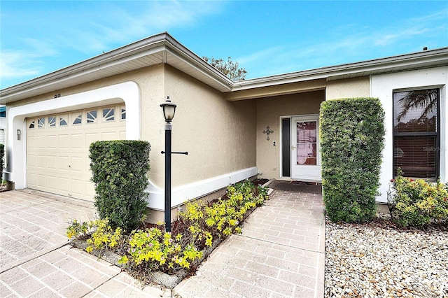 view of exterior entry with a garage