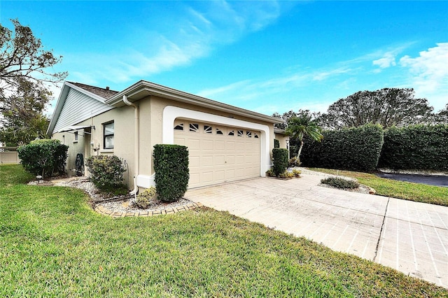 view of side of property with a garage and a lawn