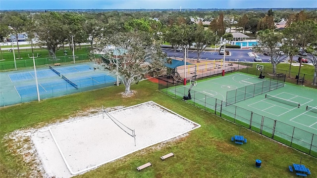 view of sport court featuring a lawn and basketball hoop