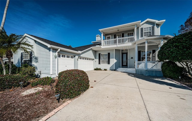 front facade with a garage, a balcony, and a porch