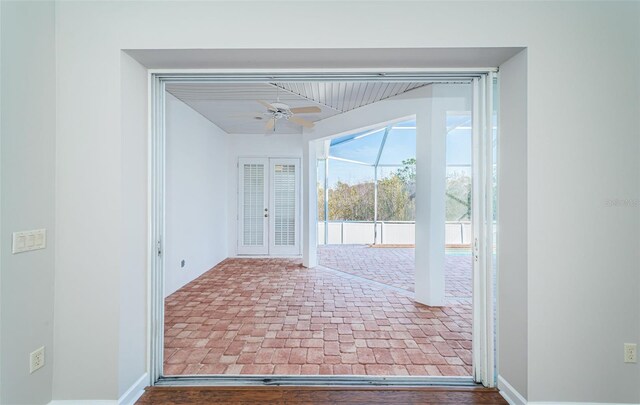 doorway to outside featuring ceiling fan