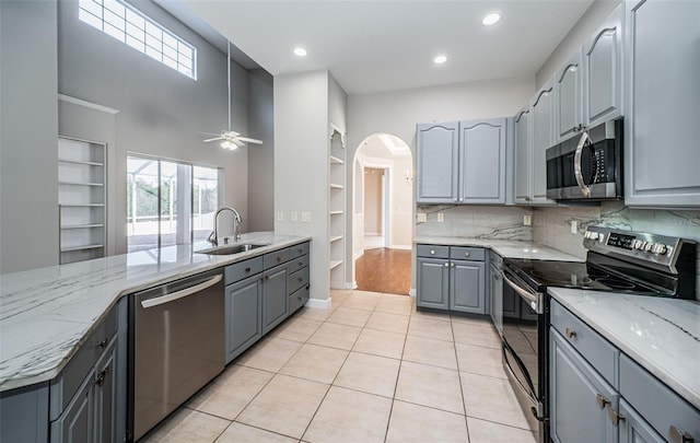 kitchen with sink, gray cabinets, plenty of natural light, and appliances with stainless steel finishes