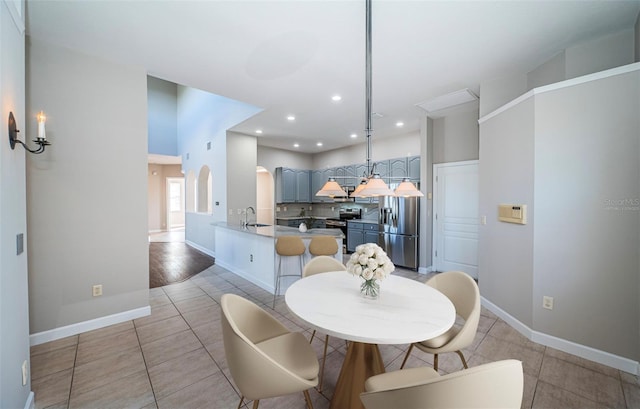 dining room featuring sink and light tile patterned floors