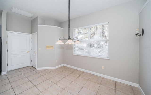 unfurnished dining area with light tile patterned flooring and a notable chandelier