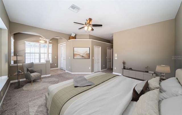 carpeted bedroom featuring two closets and ceiling fan