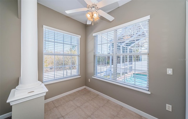 interior space featuring decorative columns and ceiling fan