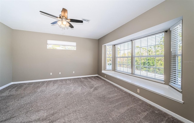 carpeted spare room featuring ceiling fan