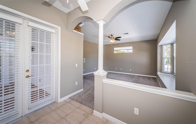 interior space featuring ceiling fan, light colored carpet, and ornate columns