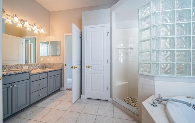 bathroom with vanity, tile patterned floors, and shower with separate bathtub