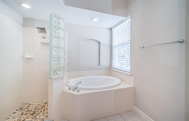 bathroom with tile patterned flooring and separate shower and tub