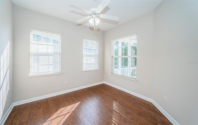 empty room featuring ceiling fan and dark hardwood / wood-style flooring