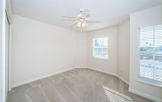 empty room with light carpet and ceiling fan