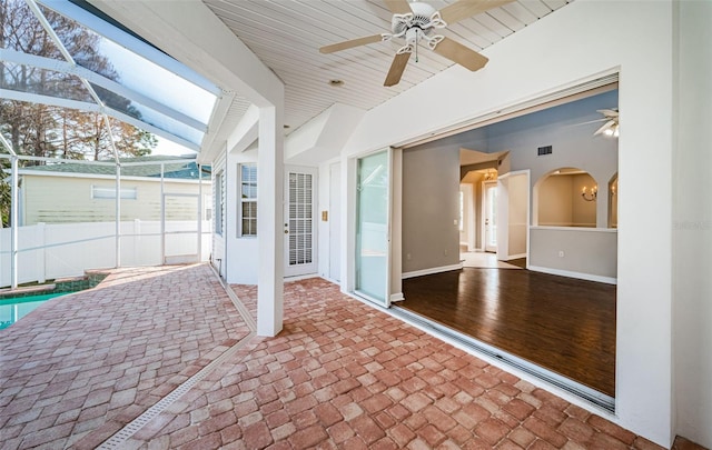 view of patio / terrace with ceiling fan and glass enclosure