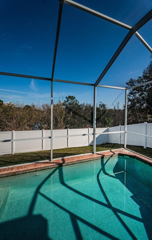 view of swimming pool with glass enclosure