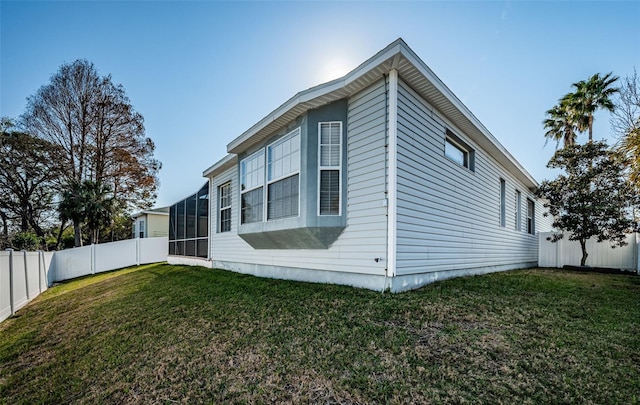 view of home's exterior with a yard