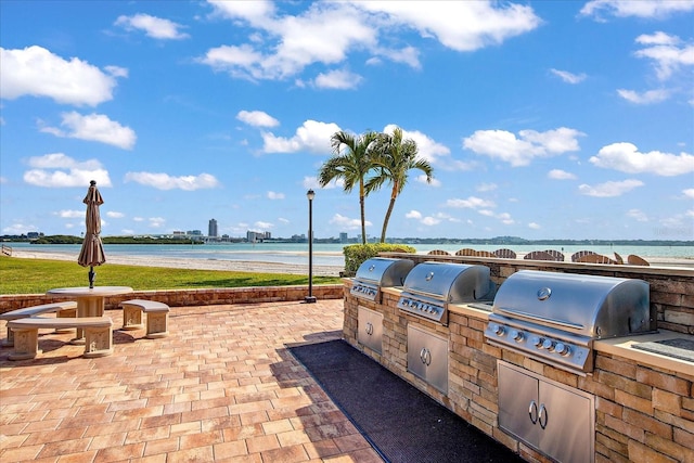 view of patio / terrace featuring area for grilling, a water view, and grilling area