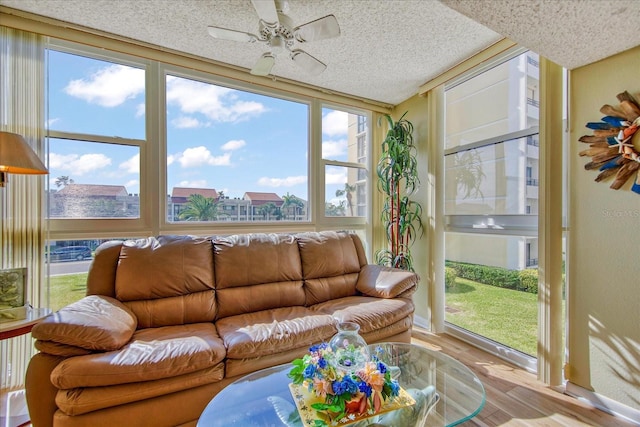 sunroom / solarium featuring ceiling fan