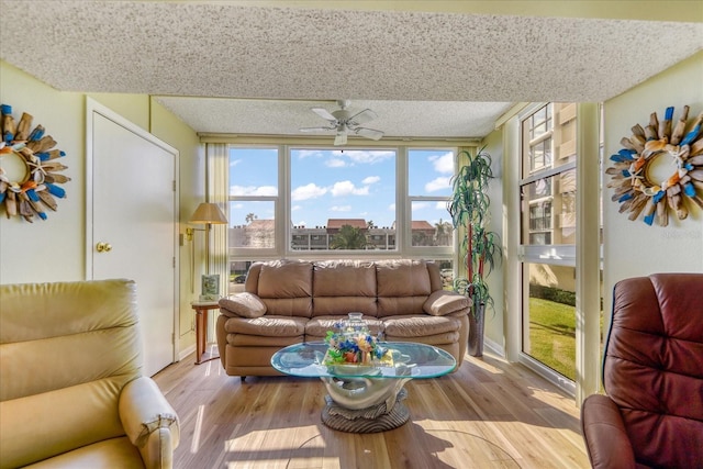 living room featuring light hardwood / wood-style floors and ceiling fan