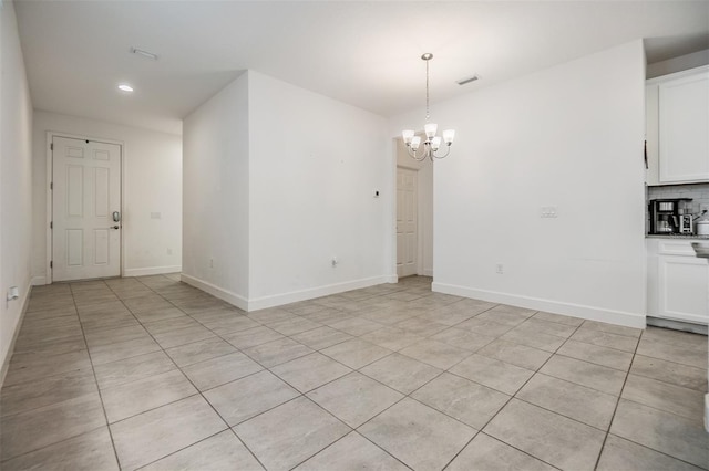 interior space with a chandelier and light tile patterned flooring