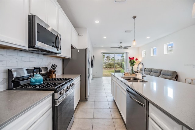 kitchen featuring sink, pendant lighting, white cabinets, and stainless steel appliances