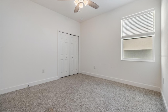 unfurnished room with ceiling fan and carpet flooring