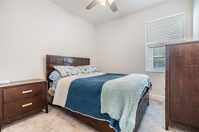 bedroom with ceiling fan and light colored carpet