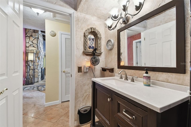 bathroom with vanity and a textured ceiling