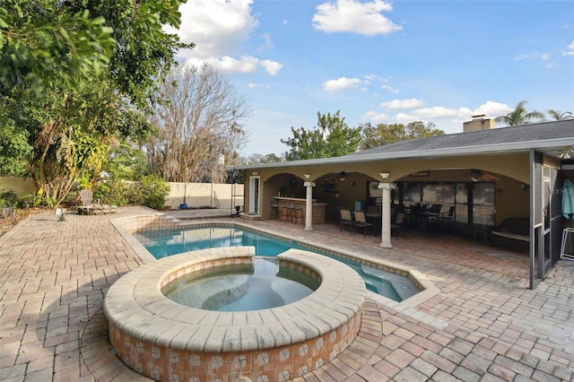 view of pool featuring a bar, an in ground hot tub, a patio area, and ceiling fan