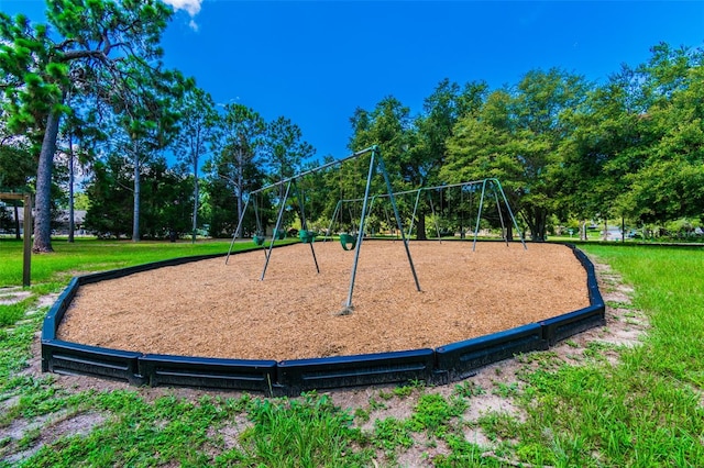 view of property's community featuring a playground and a yard