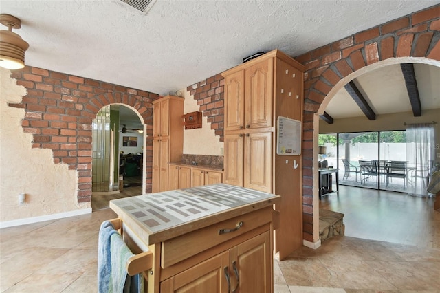 kitchen with a textured ceiling and beam ceiling