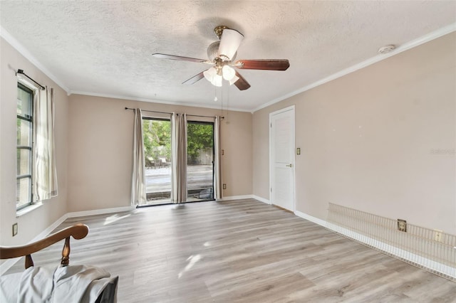 empty room featuring a textured ceiling, light hardwood / wood-style flooring, ceiling fan, and ornamental molding