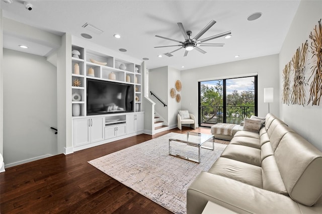 living room with ceiling fan and dark hardwood / wood-style floors