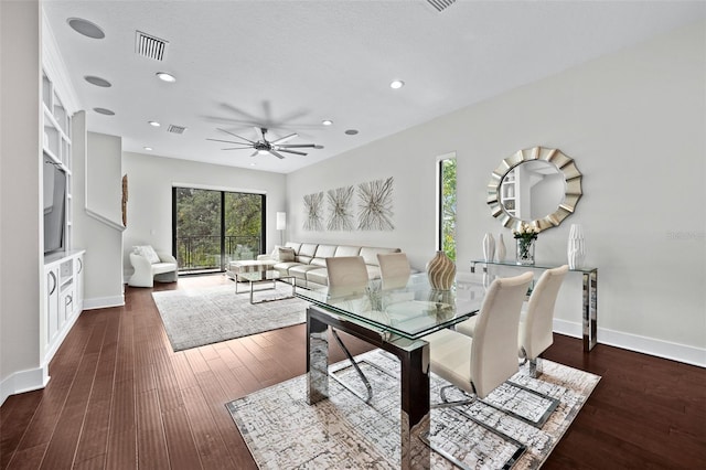 dining space featuring dark wood-type flooring and ceiling fan