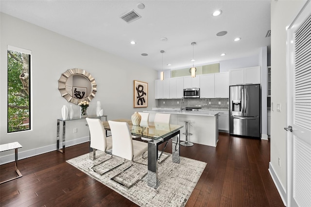 dining space featuring sink and dark hardwood / wood-style floors