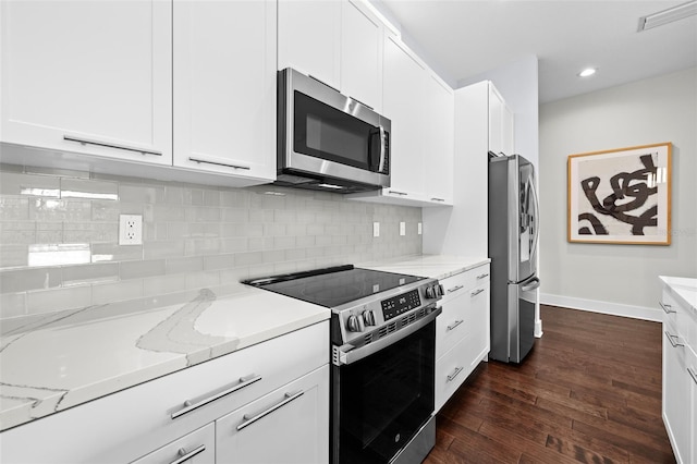 kitchen featuring white cabinets, backsplash, light stone countertops, and appliances with stainless steel finishes