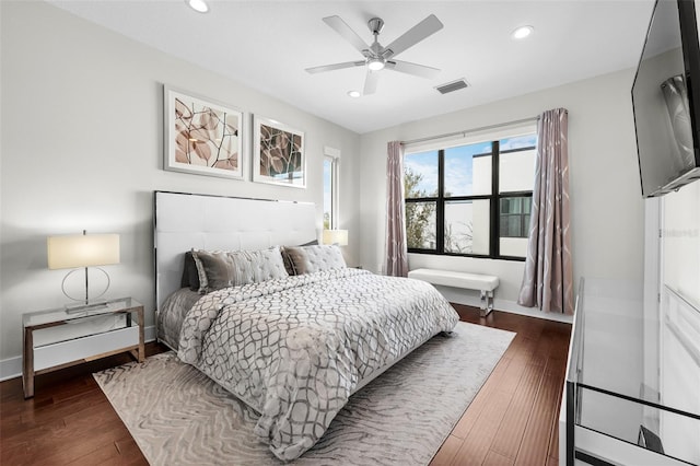 bedroom with ceiling fan and dark hardwood / wood-style floors