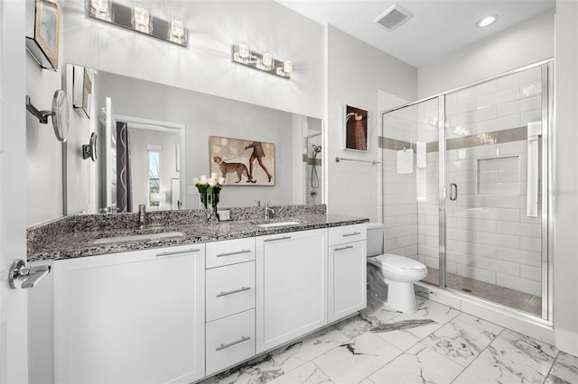 bathroom featuring toilet, an enclosed shower, and vanity