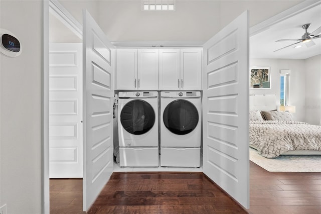 laundry room featuring cabinets, separate washer and dryer, dark hardwood / wood-style flooring, and ceiling fan