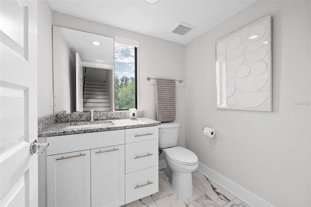 bathroom featuring toilet and vanity