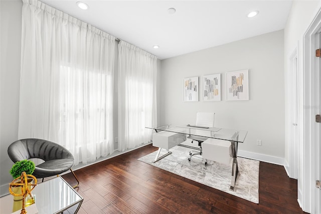 home office with dark hardwood / wood-style flooring