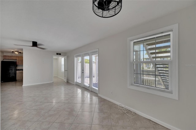 tiled spare room with ceiling fan