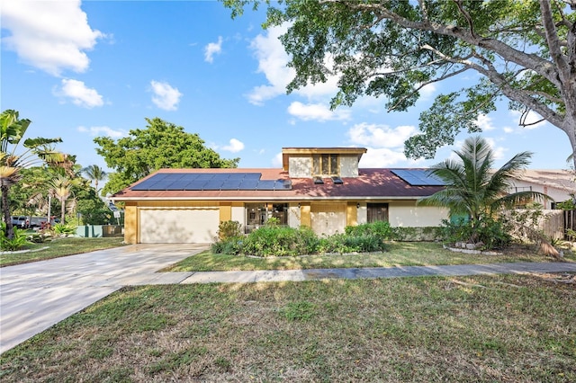 view of front of house featuring a garage, a front yard, and solar panels